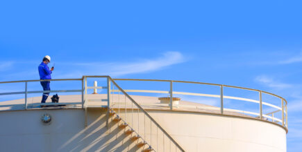 Engineer inspecting industrial storage tank